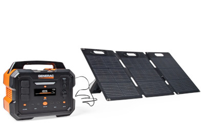 A Generac portable power station charges from a foldable solar panel.